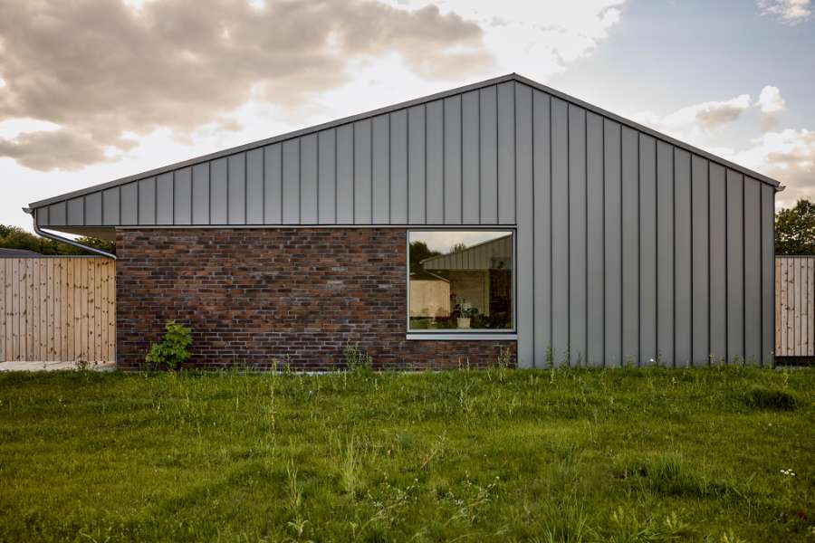 Past and future meet in steel-clad terraced houses with history in the backyard, Jernaldervej 8, 8600 Silkeborg, Denmark